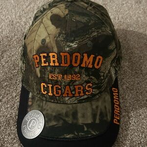 Mossy Oak Camouflage Perdomo Cigars baseball cap with a built-in bottle opener